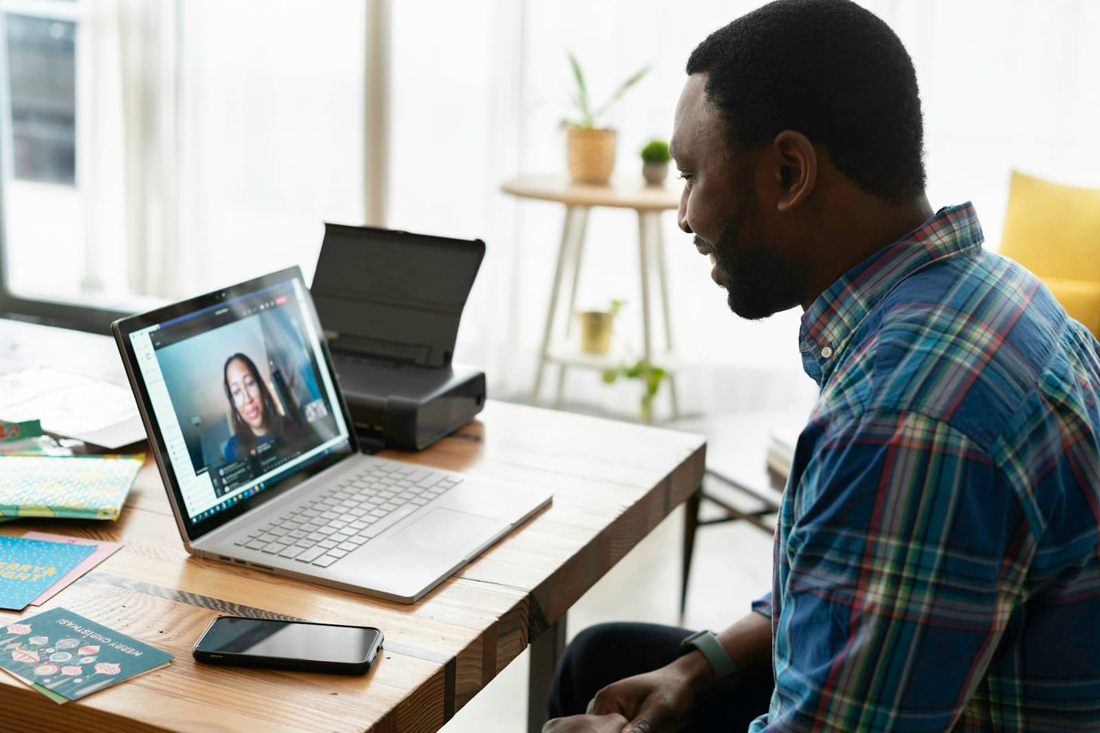 A man practicing an interview on a video call from a bright home office